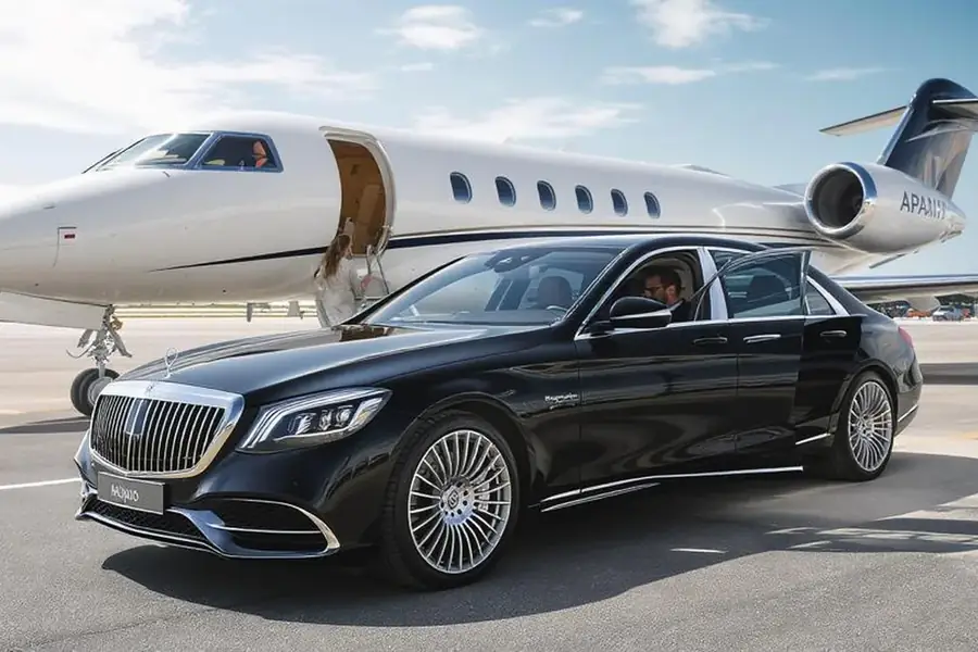 Private aviation transfer with chauffeur and luxury vehicle near private jet terminal